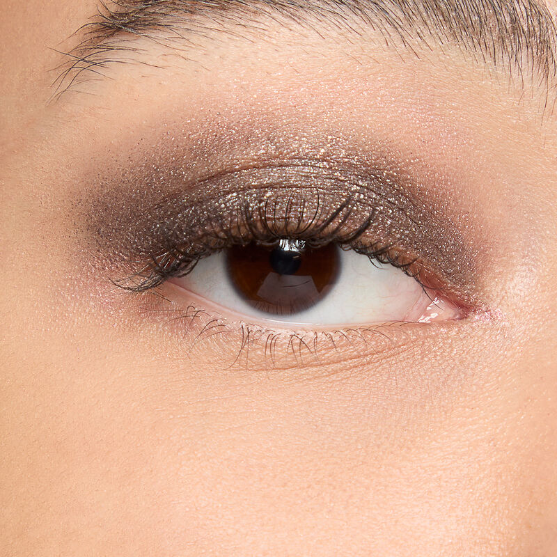 A model with a medium skin tone and brown eyes wears shade Midnight Galaxy&nbsp;