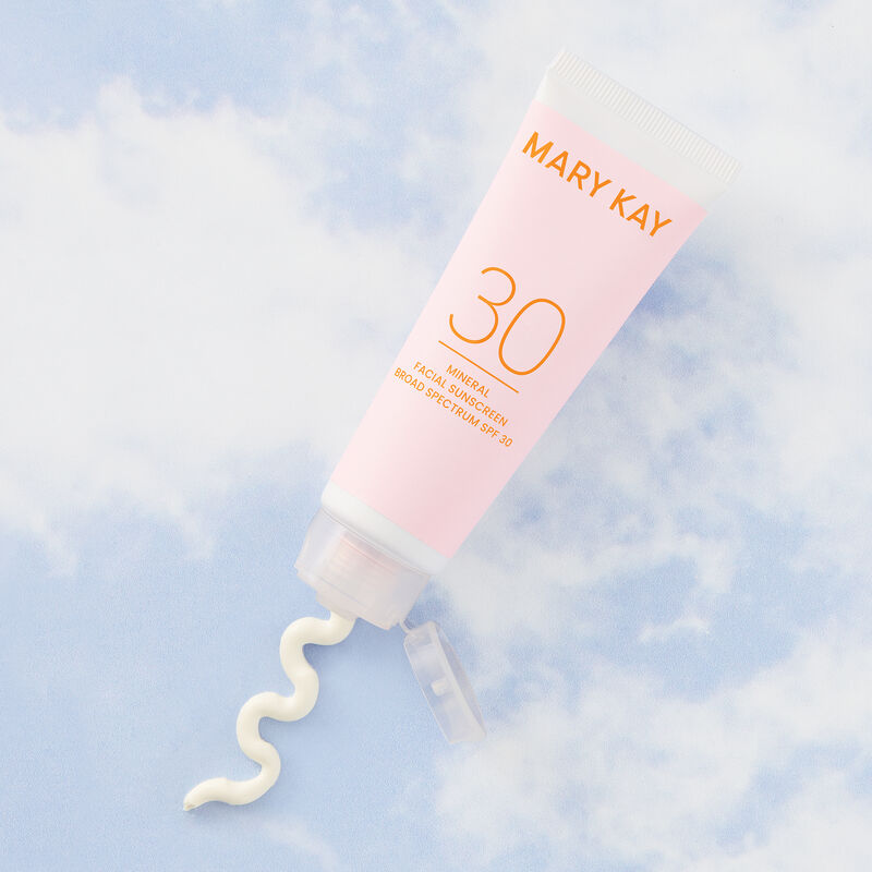 Bottle of Mary Kay Mineral Facial Sunscreen Broad Spectrum SPF 30* against blue sky with wispy white clouds image number null
