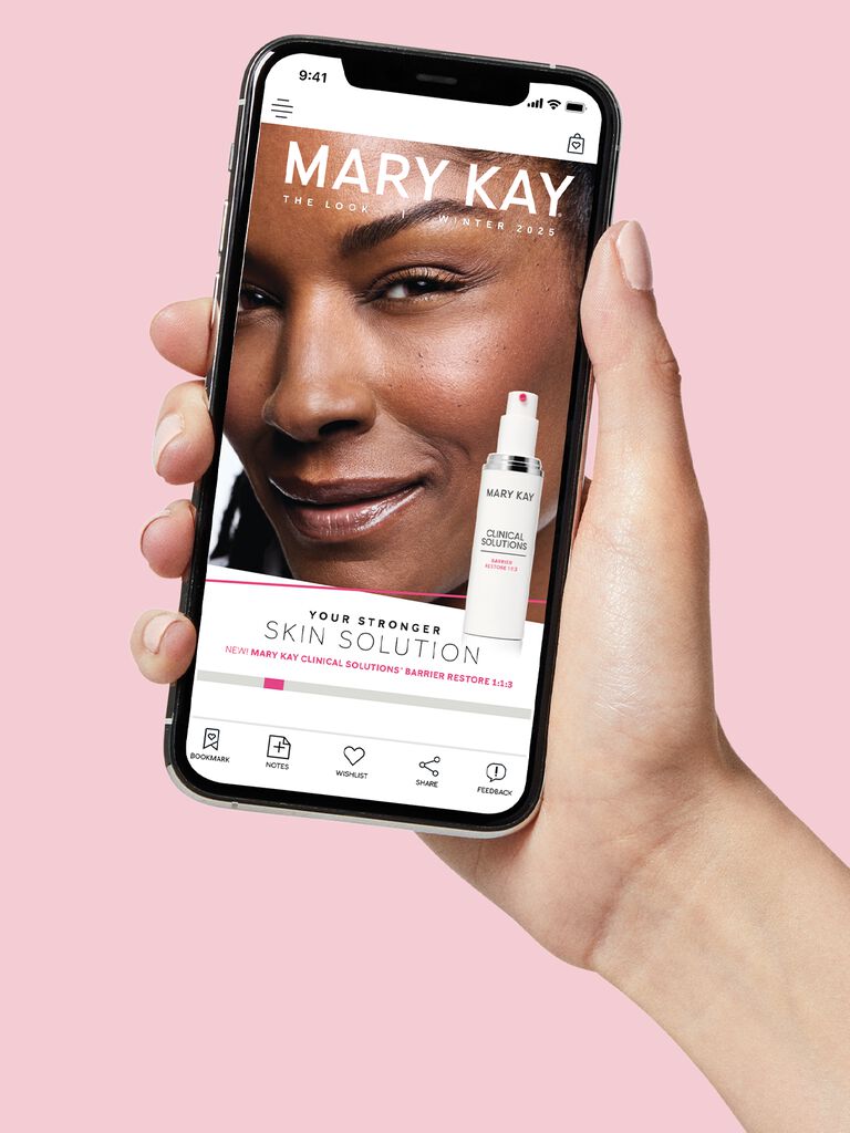 Hand holding a phone showing the Mary Kay Winter 2025 Look digital catalog.
