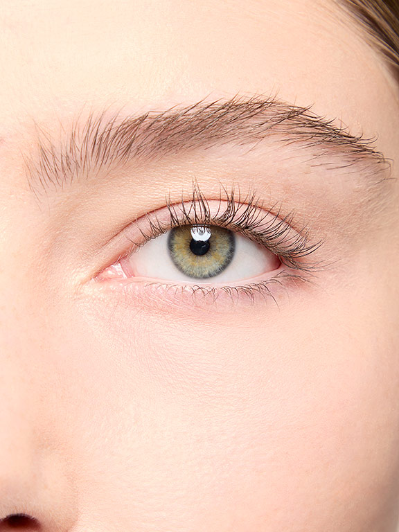 Das Auge einer Frau mit hellem Hauttyp, bevor sie Wimperntusche aufgetragen hat
